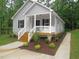 Attractive single-story home with a covered porch, complemented by lush greenery and a defined walkway at 119 Oak Ridge Rd, Franklinton, NC 27525