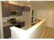 Modern kitchen featuring stainless steel appliances, dark cabinets, light countertops, and wood flooring at 119 Oak Ridge Rd, Franklinton, NC 27525