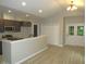 Open kitchen with stainless steel appliances, dark cabinets, eat-in bar, and wood-look flooring at 119 Oak Ridge Rd, Franklinton, NC 27525