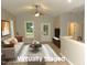 Bright, staged living room featuring a white sofa, neutral tones, and ample natural light from the window at 119 Oak Ridge Rd, Franklinton, NC 27525