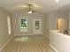 Well-lit living room with vaulted ceilings, light wood flooring, neutral tones, and large windows at 119 Oak Ridge Rd, Franklinton, NC 27525