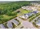 Aerial shot of a neighborhood featuring homes, a pond, and lush greenery at 1205 Quincy Cottage Rd, Hillsborough, NC 27278