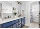 Stylish bathroom with double vanities, marble countertops, and blue cabinets at 1205 Quincy Cottage Rd, Hillsborough, NC 27278