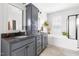Bathroom with a double vanity, granite countertop, and soaking tub with subway tile surround at 1205 Quincy Cottage Rd, Hillsborough, NC 27278