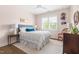 Cozy bedroom with a plush bed, bright windows, and hardwood flooring at 1205 Quincy Cottage Rd, Hillsborough, NC 27278