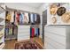 Organized walk-in closet featuring custom shelving, drawers, and a vibrant oriental rug at 1205 Quincy Cottage Rd, Hillsborough, NC 27278