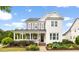 Charming two-story home showcasing a well-manicured lawn and inviting front porch at 1205 Quincy Cottage Rd, Hillsborough, NC 27278