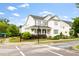Traditional two-story home exterior featuring a covered porch, nice landscaping and stylish shutters at 1205 Quincy Cottage Rd, Hillsborough, NC 27278