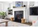 Close up of the fireplace showing built in shelving, plants and a flat screen television at 1205 Quincy Cottage Rd, Hillsborough, NC 27278