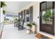 Inviting front porch with rocking chairs, potted plants, and an elegant entryway at 1205 Quincy Cottage Rd, Hillsborough, NC 27278
