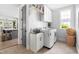 Well-equipped laundry room featuring modern washer and dryer, sink, and convenient storage solutions at 1205 Quincy Cottage Rd, Hillsborough, NC 27278
