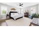 Bright bedroom with a king bed, neutral rug, and large windows with plantation shutters at 1205 Quincy Cottage Rd, Hillsborough, NC 27278