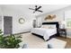 Spacious bedroom with a king bed, ceiling fan, and windows with plantation shutters at 1205 Quincy Cottage Rd, Hillsborough, NC 27278