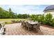 Outdoor brick patio features a dining table with seating and a beautiful natural view at 1205 Quincy Cottage Rd, Hillsborough, NC 27278