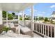Cozy covered front porch features outdoor seating and a peaceful neighborhood view at 1205 Quincy Cottage Rd, Hillsborough, NC 27278
