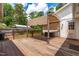 Wooden back deck featuring an awning and string lights, offering a relaxing outdoor space at 1209 Maple Ave, Apex, NC 27502