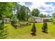 Spacious backyard featuring a charming garden area with a raised garden bed at 1209 Maple Ave, Apex, NC 27502