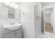 Bathroom showcasing a vanity, framed mirror, and half wall wainscoting at 1209 Maple Ave, Apex, NC 27502