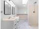 Bright bathroom with double vanity, stand up shower, bathtub, and modern fixtures at 1209 Maple Ave, Apex, NC 27502