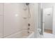 Bathroom featuring a shower-tub combo and a white marbled tile floor at 1209 Maple Ave, Apex, NC 27502
