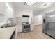 Open concept kitchen with stainless steel appliances, ample cabinet space, and modern lighting at 1209 Maple Ave, Apex, NC 27502