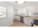 Bright kitchen features stainless steel appliances, ample counter space, and white cabinets, for a modern aesthetic at 1209 Maple Ave, Apex, NC 27502