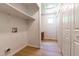 Bright laundry room with ample storage and hardwood floors at 1209 Maple Ave, Apex, NC 27502