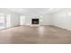 Bright living room with a fireplace, beautiful flooring, and access to the outdoors through french doors at 1209 Maple Ave, Apex, NC 27502