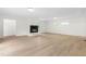 Spacious living room boasts a modern fireplace with sleek flooring and recessed lighting throughout at 1209 Maple Ave, Apex, NC 27502