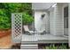 Outdoor back porch featuring two lounge chairs and a lattice privacy screen at 123 Chimney Rise Dr, Cary, NC 27511