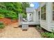 This back porch features two lounge chairs and is nestled in a leafy, secluded spot at 123 Chimney Rise Dr, Cary, NC 27511