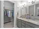 Bright bathroom with double sinks, granite countertops, and access to a walk-in closet at 123 Chimney Rise Dr, Cary, NC 27511