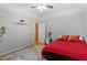 Spacious bedroom with hardwood floors, a red comforter and an accent wall at 123 Chimney Rise Dr, Cary, NC 27511