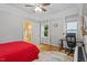 Well-lit bedroom featuring hardwood floors, a ceiling fan and two windows allowing ample light at 123 Chimney Rise Dr, Cary, NC 27511