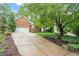 Charming brick home with a spacious driveway and lush greenery, offering an inviting curb appeal at 123 Chimney Rise Dr, Cary, NC 27511
