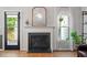 Close-up on fireplace showcasing the mantle, door to the outside, and natural light from the window at 123 Chimney Rise Dr, Cary, NC 27511