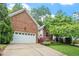 Beautiful brick home featuring an attached two-car garage, lovely landscaping, and an inviting curb appeal at 123 Chimney Rise Dr, Cary, NC 27511