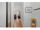 Inviting hallway leading to living area showcasing neutral walls, and a glimpse of the fireplace at 123 Chimney Rise Dr, Cary, NC 27511