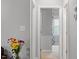 Hallway showcasing hardwood floors, light gray paint and access to a bedroom at 123 Chimney Rise Dr, Cary, NC 27511