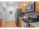 Galley kitchen with gray appliances, tile backsplash, and a door to the outside at 123 Chimney Rise Dr, Cary, NC 27511