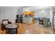 Open-concept living area with hardwood floors, a cozy seating area, and a modern kitchen in the background at 123 Chimney Rise Dr, Cary, NC 27511