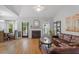 Bright living room featuring a fireplace, dining area, hardwood floors and comfortable seating at 123 Chimney Rise Dr, Cary, NC 27511
