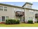 Backyard showcasing a multi-level deck with a view of the green lawn and mature shrubs at 127 Manordale Dr, Chapel Hill, NC 27517