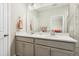 Bright bathroom featuring a double vanity with stone countertops and a large mirror at 127 Manordale Dr, Chapel Hill, NC 27517
