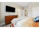 Modern bedroom with a large TV, dresser, and ensuite bathroom with modern fixtures at 127 Manordale Dr, Chapel Hill, NC 27517