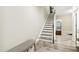 Bright entryway features staircase and gray floors, leading to a partially visible room at 127 Manordale Dr, Chapel Hill, NC 27517
