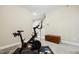 Home gym area features a Peloton bike and a chest for storage at 127 Manordale Dr, Chapel Hill, NC 27517