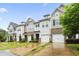 Row of townhomes with brick and vinyl siding, attached garages, and green lawns at 127 Manordale Dr, Chapel Hill, NC 27517