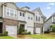 Attractive townhomes feature brick accents, attached garages, and manicured landscaping at 127 Manordale Dr, Chapel Hill, NC 27517
