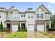 Charming townhomes boast brick accents, inviting garages, and well-manicured lawns at 127 Manordale Dr, Chapel Hill, NC 27517